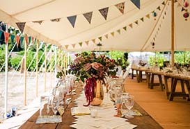 Laid tables inside the marquee