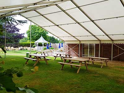 A marquee provides cover in a bar garden at a golf course