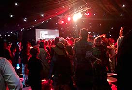 Blacked out marquee with night sky roof lighting, a lighting bar and a red colour wash